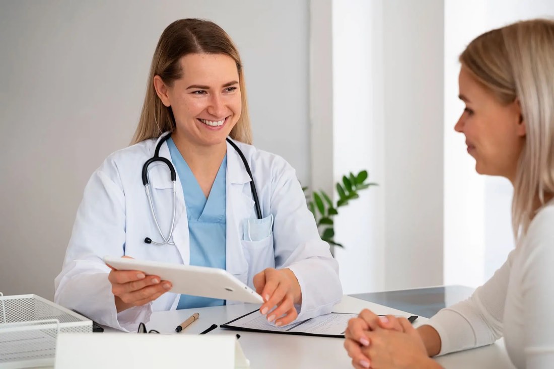 A doctor smiling with a patient at the Apex clinic